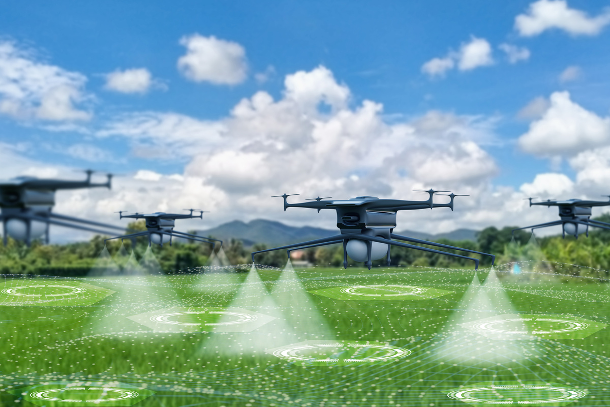 Aerial view futuristic agricultural drone,spraying chemicals or organic fertilizers into water droplets in agricultural areas fields,concept technology,modern agriculture with artificial intelligence